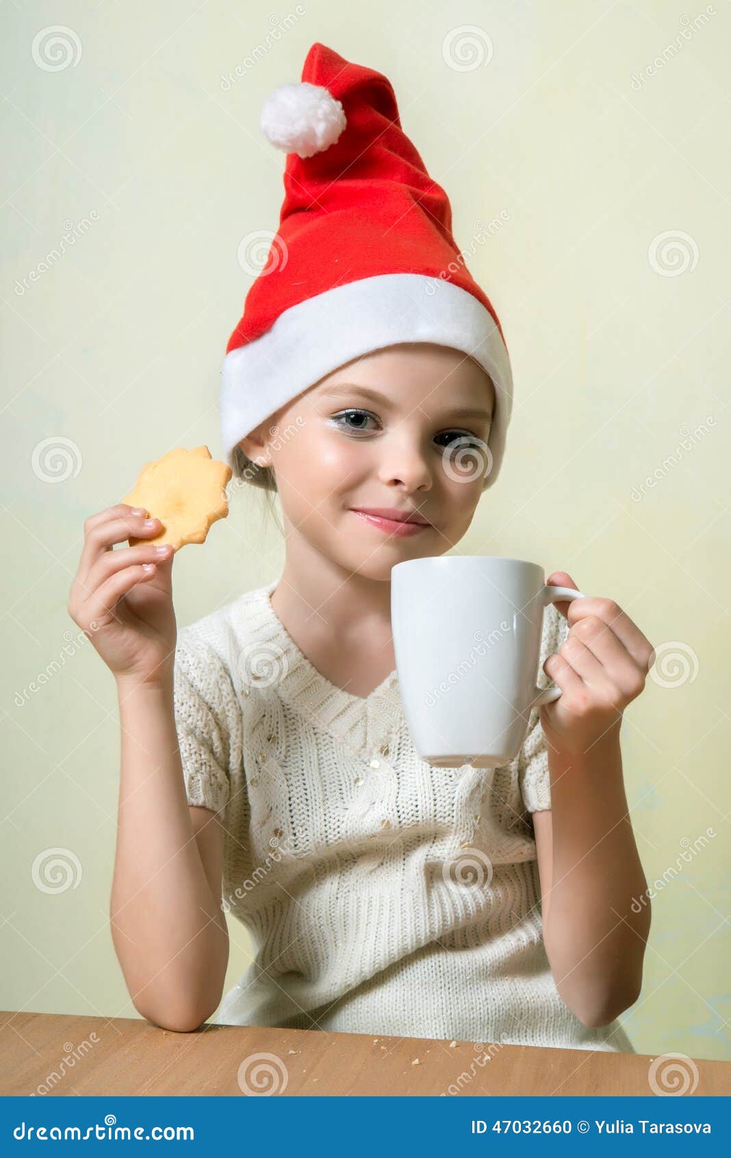 ÃÂ¡ute girl in santa claus hat eat cookies.